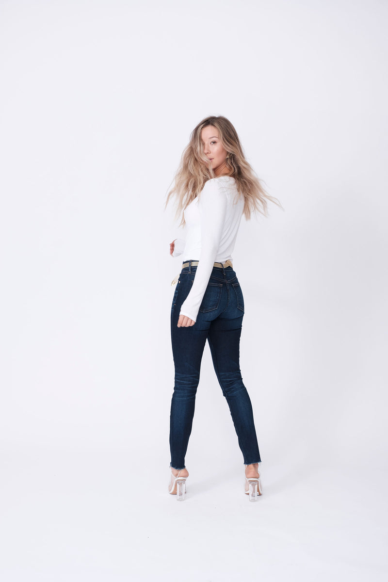 Back View of Midheaven's Mid-Rise Raw Hem Skinny   ITEM RUNS SMALL, CONSIDER SIZING UP   Details: Model is 5’7” and is wearing 4" heels. Rise: 9” Inseam: 28” Leg Opening: 10.5” Fabric contents: 98%Cotton - 2%Elastane