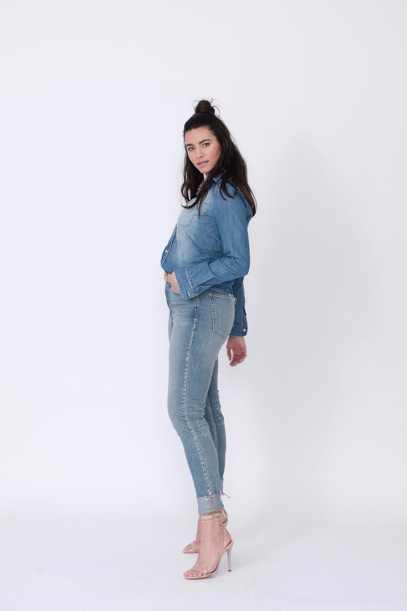 Side View of Midheaven's High-Rise Vintage Wash Button Fly Skinny w/ Raw Hem    Details: Model is 5' 9" and is wearing 4" heels. Rise: 10 3/4” Inseam: 28” Leg Opening: 10.5” Fabric contents: 98% Cotton - 2% Elastane