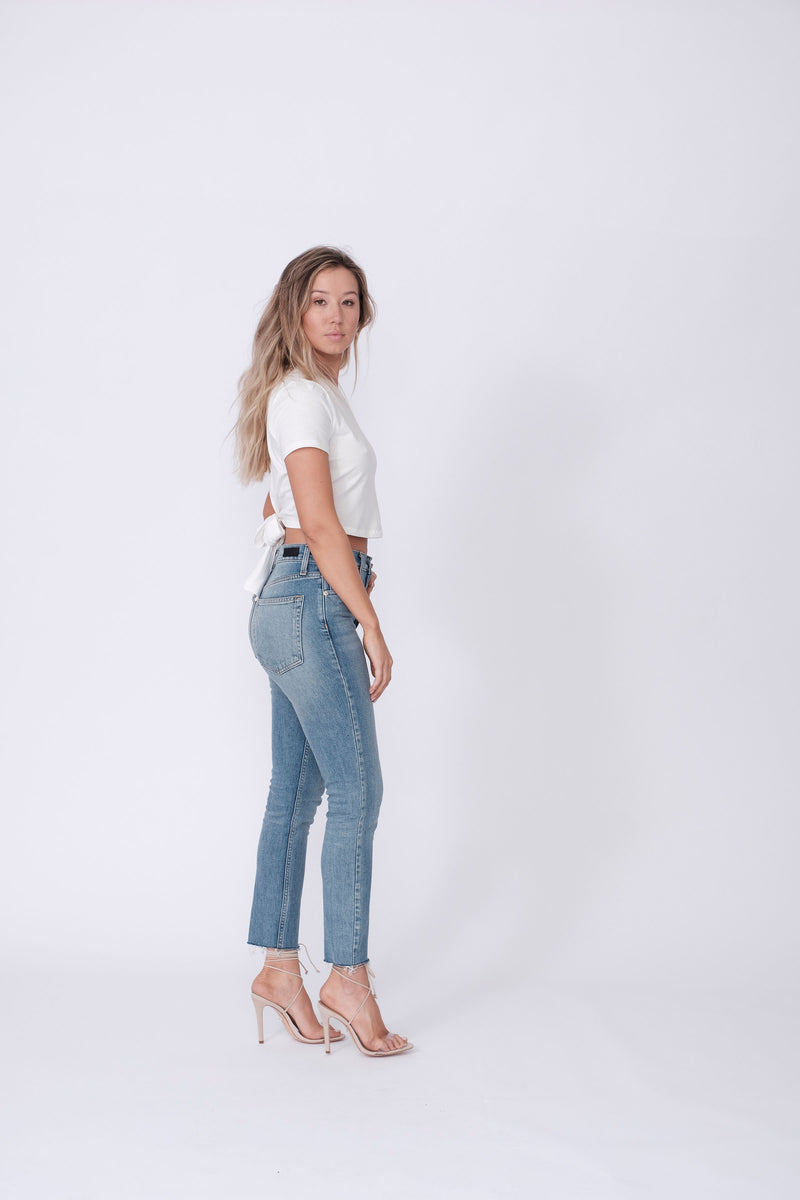 Side View of Midheaven's High-Rise Vintage Wash Button Fly Skinny w/ Raw Hem    Details: Model is 5' 7" and is wearing 4" heels. Rise: 10 3/4” Inseam: 28” Leg Opening: 10.5” Fabric contents: 98% Cotton - 2% Elastane