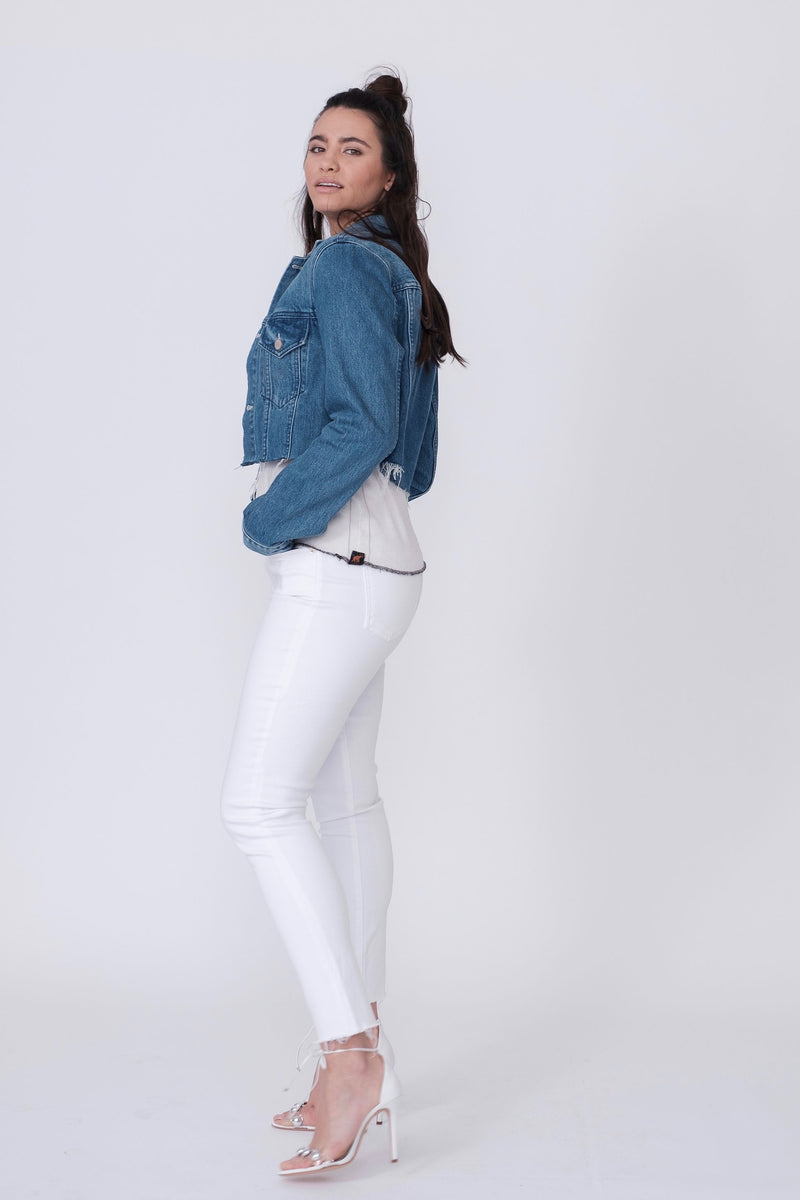 Side View of Midheaven's Mid-Rise White Skinny w/ Raw Hem     Details: Model is 5'10" and is wearing 4" heels. Rise: 9.75” Inseam: 29” Leg Opening: 10” Fabric contents: 98% Cotton - 2% Elastane