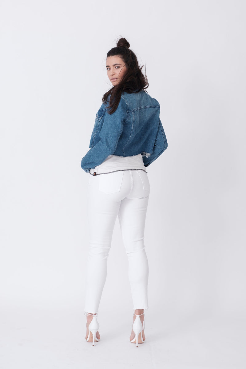 Back View of Midheaven's Mid-Rise White Skinny w/ Raw Hem     Details: Model is 5'10" and is wearing 4" heels. Rise: 9.75” Inseam: 29” Leg Opening: 10” Fabric contents: 98% Cotton - 2% Elastane
