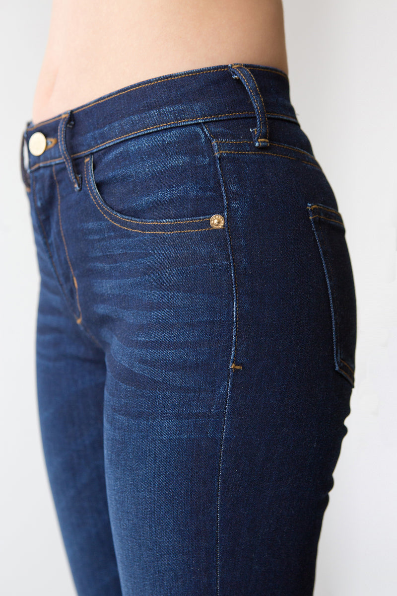 Side View Up Close of Midheaven's Mid-Rise Indigo Skinny  ITEM RUNS SMALL, CONSIDER SIZING UP ONE SIZE  Details: Model is 5’10” and is wearing 4" heels. Rise: 9” Inseam: 33” Leg Opening: 10.5” Fabric contents: 98%Cotton - 2%Elastane
