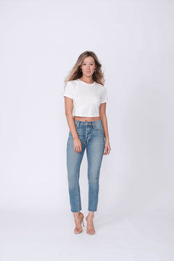 Front View of Midheaven's High-Rise Vintage Wash Button Fly Skinny w/ Raw Hem    Details: Model is 5' 7" and is wearing 4" heels. Rise: 10 3/4” Inseam: 28” Leg Opening: 10.5” Fabric contents: 98% Cotton - 2% Elastane