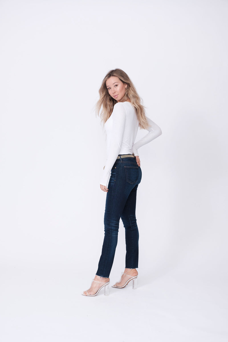 Side View of Midheaven's Mid-Rise Raw Hem Skinny   ITEM RUNS SMALL, CONSIDER SIZING UP   Details: Model is 5’7” and is wearing 4" heels. Rise: 9” Inseam: 28” Leg Opening: 10.5” Fabric contents: 98%Cotton - 2%Elastane