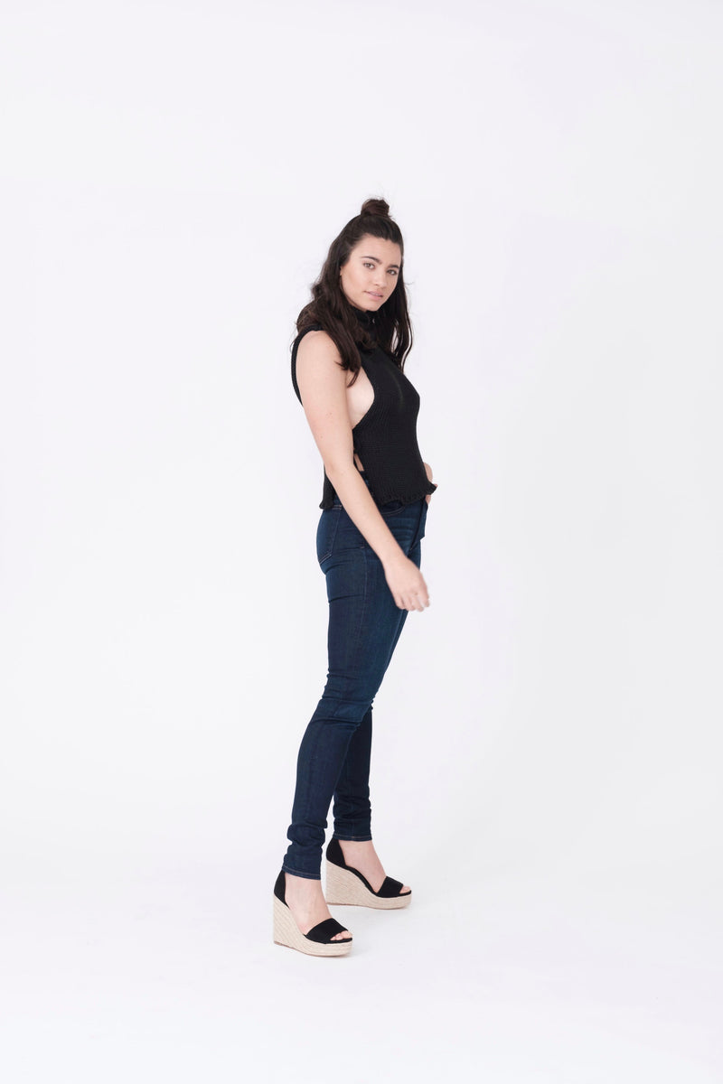 Side View of Midheaven's Mid-Rise Indigo Skinny  ITEM RUNS SMALL, CONSIDER SIZING UP ONE SIZE  Details: Model is 5’10” and is wearing 4" heels. Rise: 9” Inseam: 33” Leg Opening: 10.5” Fabric contents: 98%Cotton - 2%Elastane