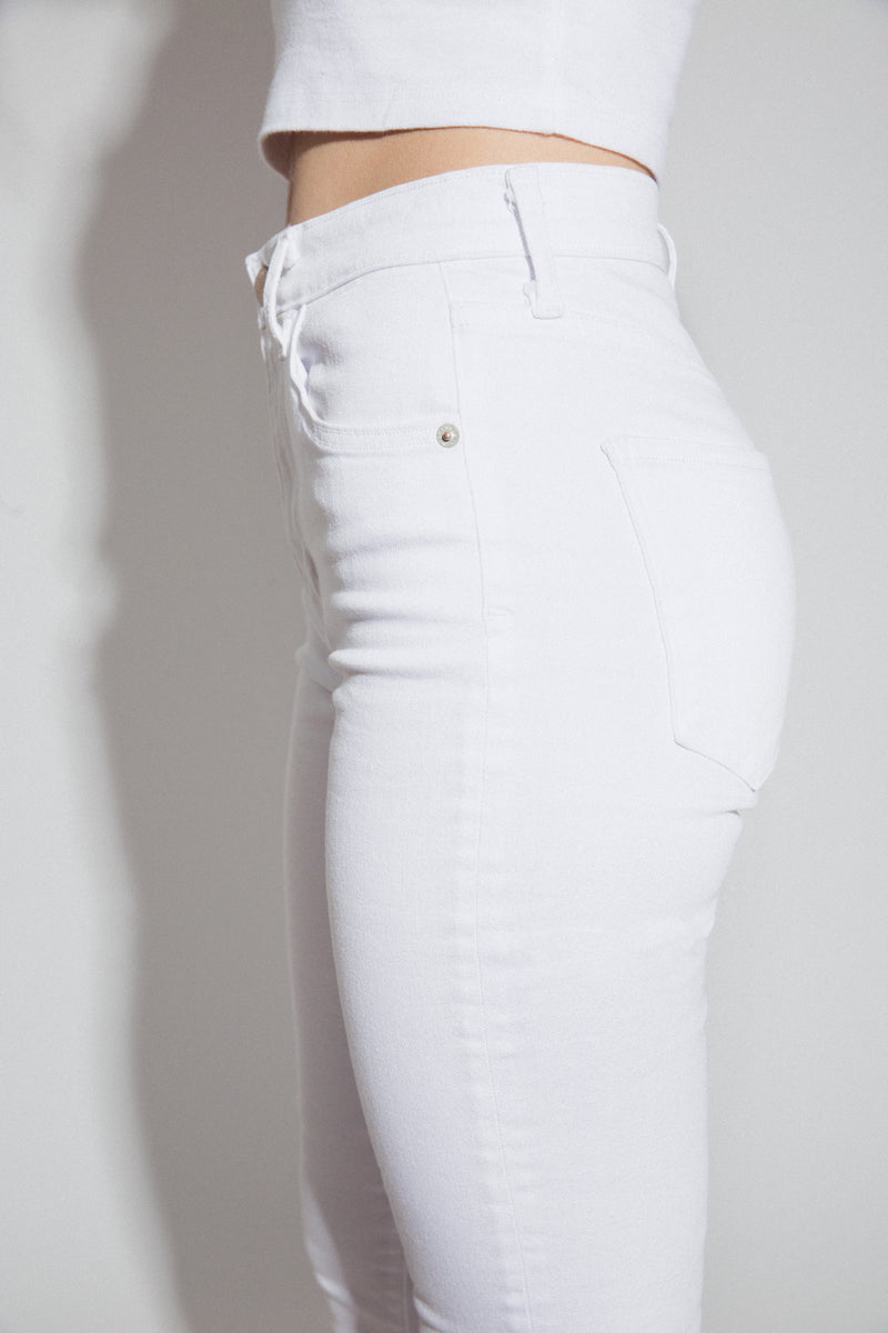 Side View Up Close of Midheaven's Mid-Rise White Flare     Details: Model is 6’ and is wearing 4" heels. Rise: 9.75” Inseam: 38” Leg Opening: 21” Fabric contents: 98% Cotton - 2% Elastane NOTE: Fabric will stretch with wear. Consider sizing down.