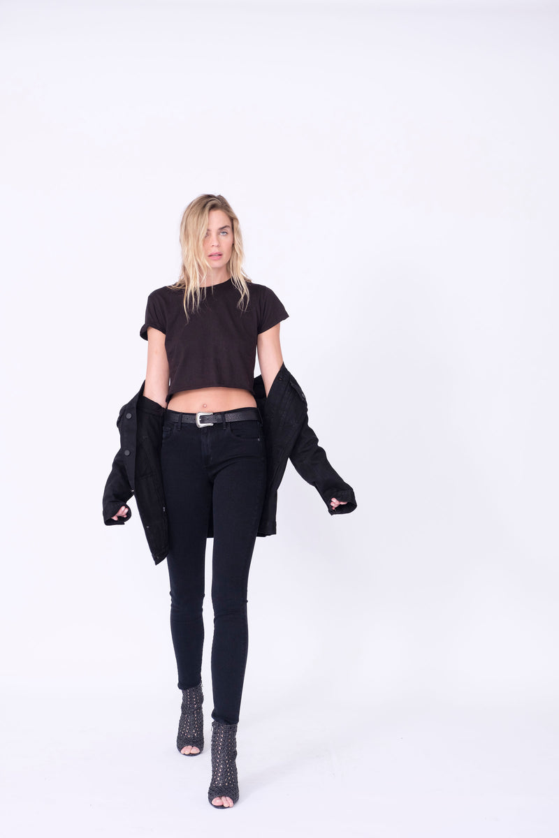 Front View of Midheaven's Mid-Rise Black Skinny  Details: Model is 6' and is wearing 4" heels. Rise: 9” Inseam: 33” Leg Opening: 10.5” Fabric contents: 98%Cotton - 2%Elastane     Note: We suggest sizing up. The Astrid runs small.
