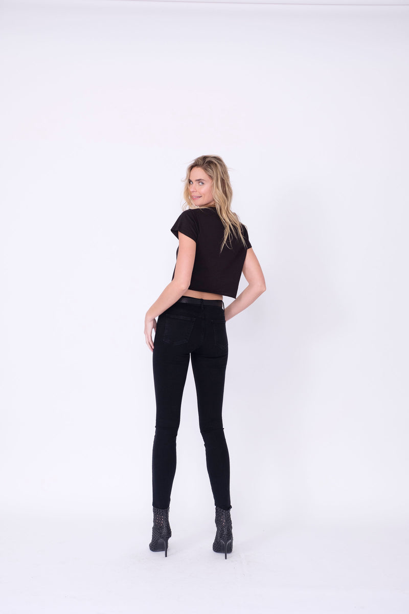 Back View of Midheaven's Mid-Rise Black Skinny  Details: Model is 5’10” and is wearing 4" heels. Rise: 9” Inseam: 33” Leg Opening: 10.5” Fabric contents: 98%Cotton - 2%Elastane     Note: We suggest sizing up. The Astrid runs small.