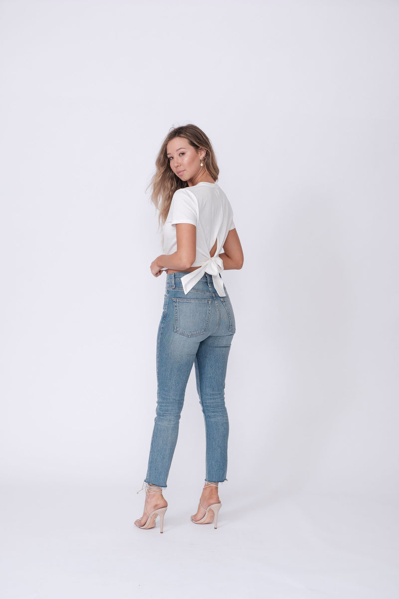Back View of Midheaven's High-Rise Vintage Wash Button Fly Skinny w/ Raw Hem    Details: Model is 5' 7" and is wearing 4" heels. Rise: 10 3/4” Inseam: 28” Leg Opening: 10.5” Fabric contents: 98% Cotton - 2% Elastane