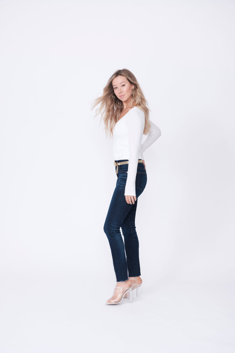 Side View of Midheaven's Mid-Rise Raw Hem Skinny   ITEM RUNS SMALL, CONSIDER SIZING UP   Details: Model is 5’7” and is wearing 4" heels. Rise: 9” Inseam: 28” Leg Opening: 10.5” Fabric contents: 98%Cotton - 2%Elastane