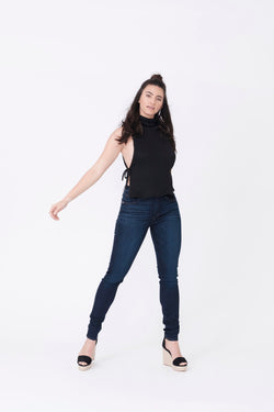 Front View of Midheaven's Mid-Rise Indigo Skinny  ITEM RUNS SMALL, CONSIDER SIZING UP ONE SIZE  Details: Model is 5’10” and is wearing 4" heels. Rise: 9” Inseam: 33” Leg Opening: 10.5” Fabric contents: 98%Cotton - 2%Elastane