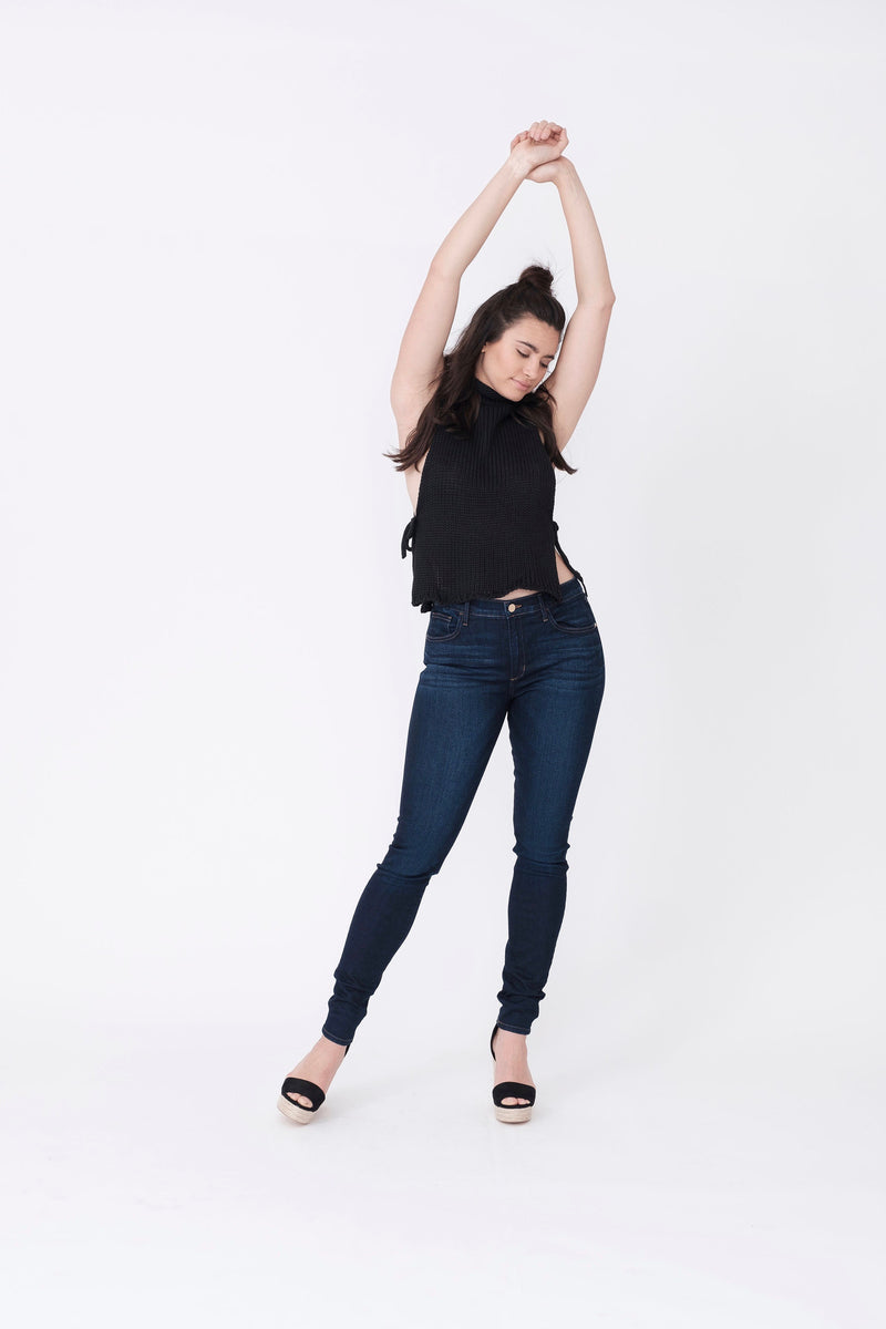 Front View of Midheaven's Mid-Rise Indigo Skinny  ITEM RUNS SMALL, CONSIDER SIZING UP ONE SIZE  Details: Model is 5’10” and is wearing 4" heels. Rise: 9” Inseam: 33” Leg Opening: 10.5” Fabric contents: 98%Cotton - 2%Elastane