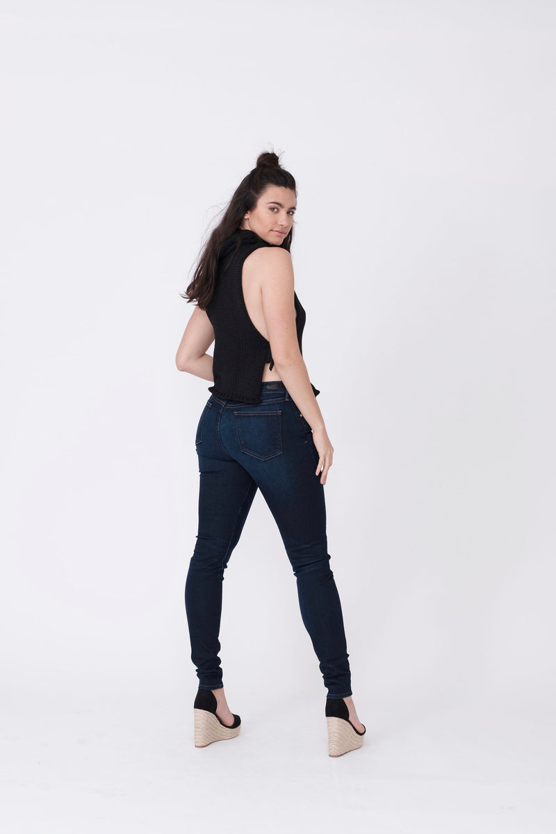 Back View of Midheaven's Mid-Rise Indigo Skinny  ITEM RUNS SMALL, CONSIDER SIZING UP ONE SIZE  Details: Model is 5’10” and is wearing 4" heels. Rise: 9” Inseam: 33” Leg Opening: 10.5” Fabric contents: 98%Cotton - 2%Elastane