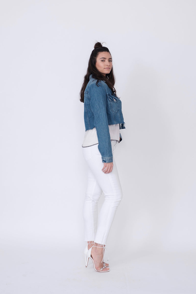 Side View of Midheaven's Mid-Rise White Skinny w/ Raw Hem     Details: Model is 5'10" and is wearing 4" heels. Rise: 9.75” Inseam: 29” Leg Opening: 10” Fabric contents: 98% Cotton - 2% Elastane